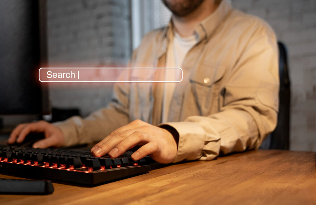 Zero Click Searches: A man focused on a keyboard marked with "search," highlighting the idea of Zero Click Searches.